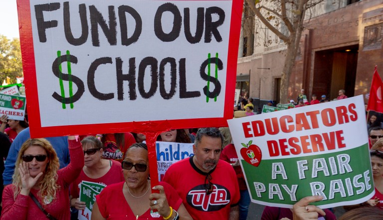 In this Saturday, Dec. 15, 2018, photo, thousands of teachers marched and rallied in downtown Los Angeles. Teachers in the nation's second-largest school district will go on strike next month if there's no settlement of its long-running contract dispute, union leaders said Wednesday, Dec. 19. The announcement by United Teachers Los Angeles threatens the first strike against the Los Angeles Unified School District in nearly 30 years and follows about 20 months of negotiations.