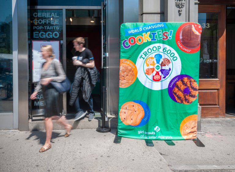 A sign outside the Kellogg's restaurant in Union Square in New York announces the sale inside of Girl Scout Cookies by Troop 6000, which consists of homeless girls.