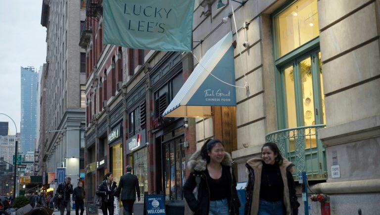 In this Thursday, April 11, 2019 photo, pedestrians walk past the Lucky Lee's restaurant in the Greenwich Village neighborhood of New York. The owner has drawn backlash for touting offerings of âcleanâ American-Chinese cuisine, renewing debate about cultural appropriation in the restaurant world.