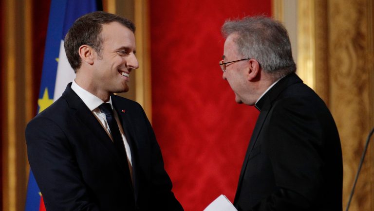 FILE - In this Jan.4, 2018 file photo, French President Emmanuel Macron greets Apostolic Nuncio to France Luigi Ventura during his New Year address to diplomats at the Elysee Palace in Paris. The Paris prosecutor's office has opened an investigation into alleged "sexual aggression" by Luigi Ventura, the Vatican's envoy to France, according to a French judicial official. 
