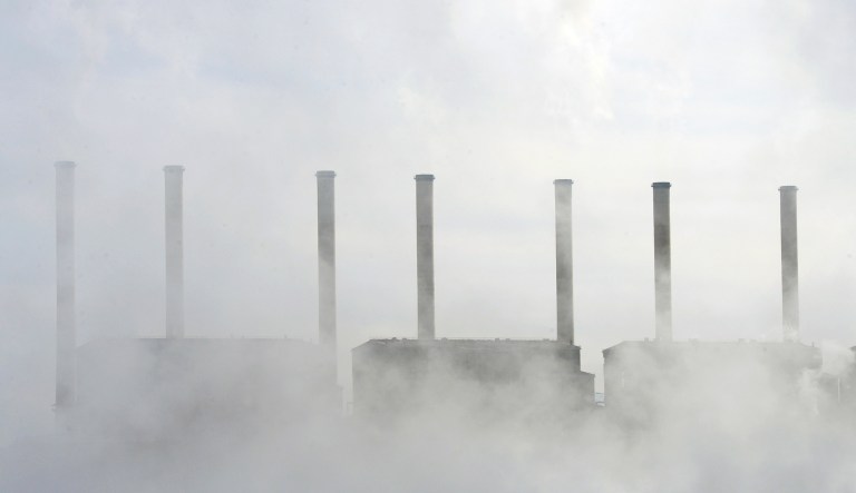 Morning mist surrounds cooling towers of a coal plant on Jul. 25, 2013.