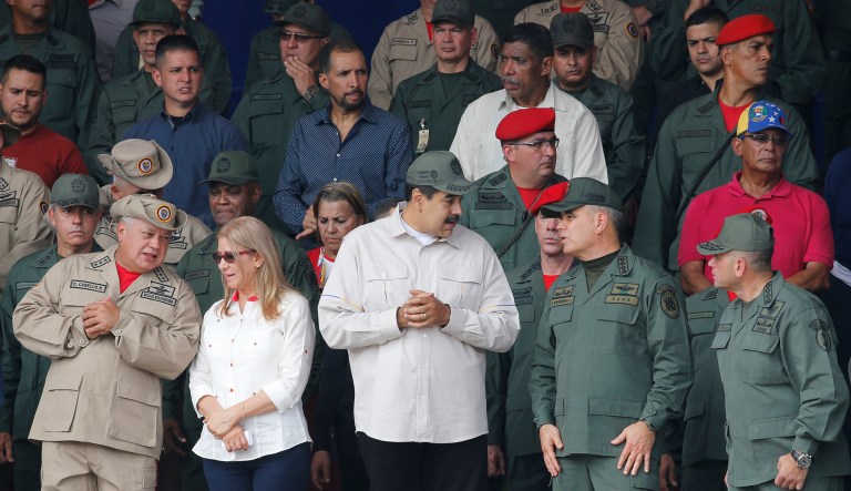 From left to right, front line, Diosdado Cabello, Venezuela's socialist party boss and president of the National Constituent Assembly speaks to first lady Cilia Flores, as Venezuela's President Nicolas Maduro speaks to Defense Minister Vladimir Padrino Lopez and on the right corner Admiral Remigio Ceballos, Chief of Staff of the Armed Forces Strategic Operational Command during the tenth anniversary celebration of the Bolivarian militia in Caracas, Venezuela, Saturday, April 13, 2019.