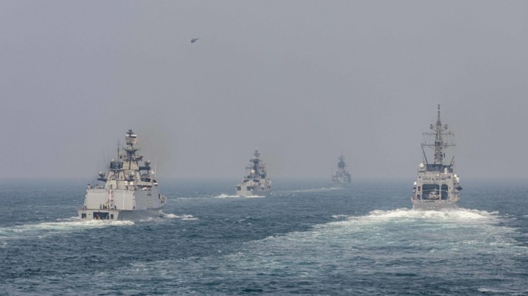 The Arleigh Burke-class guided-missile destroyer USS John S. McCain sails in formation with ships from the Indian Navy, Royal Australian Navy, and Japan Maritime Self-Defense Force while conducting replenishment-at-sea approaches as part of the naval exercise Malabar 2020. 