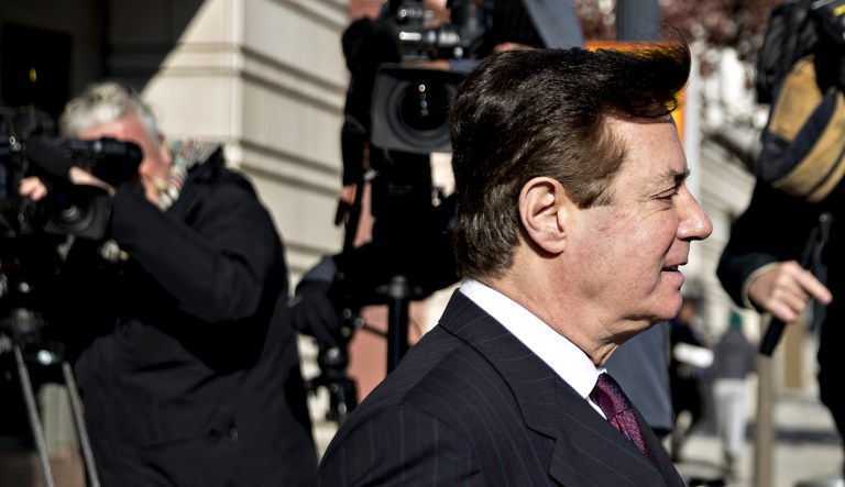 Paul Manafort walks out of a federal courthouse.
