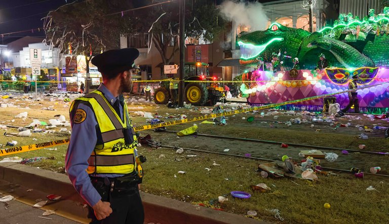 Police work the scene of a shooting at the Krewe of Bacchus parade on Sunday, Feb. 19, 2023.  Five people were shot, including a young girl, during a Mardi Gras parade in New Orleans, police said, and a suspect was in custody. 