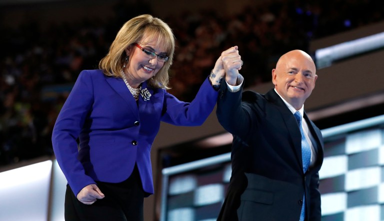 Former Rep. Gabby Giffords, D-Ariz, and her husband Astronaut Mark Kelly (ret.), walk off the stage after speaking during the third day session of the Democratic National Convention in Philadelphia, Wednesday, July 27, 2016.