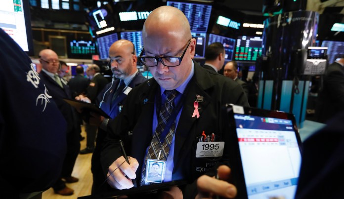 Trader Jeffrey Vazquez, center, works on the floor of the New York Stock Exchange, Monday, Nov. 4, 2019. Stocks are opening higher on Wall Street, pushing major indexes toward more record highs. 
