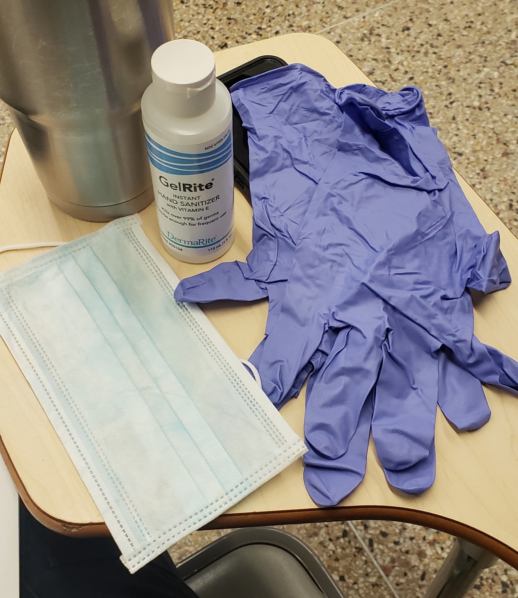 Shown above are a bottle of hand sanitizer, a mask, and a pair of gloves given to an NYPD officer.