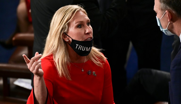 Rep. Marjorie Taylor Greene (R-GA) speaks to a colleague with her 