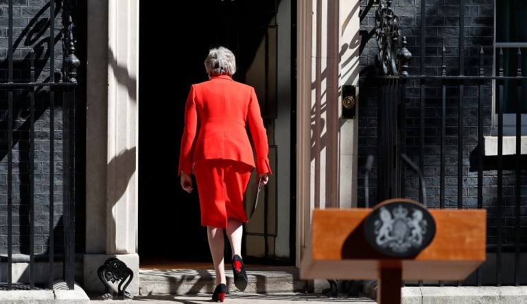 British Prime Minister Theresa May walks away after making a speech in the street outside 10 Downing Street in London, England, Friday, May 24, 2019. Theresa May says she'll quit as UK Conservative leader on June 7, sparking contest for Britain's next prime minister. 