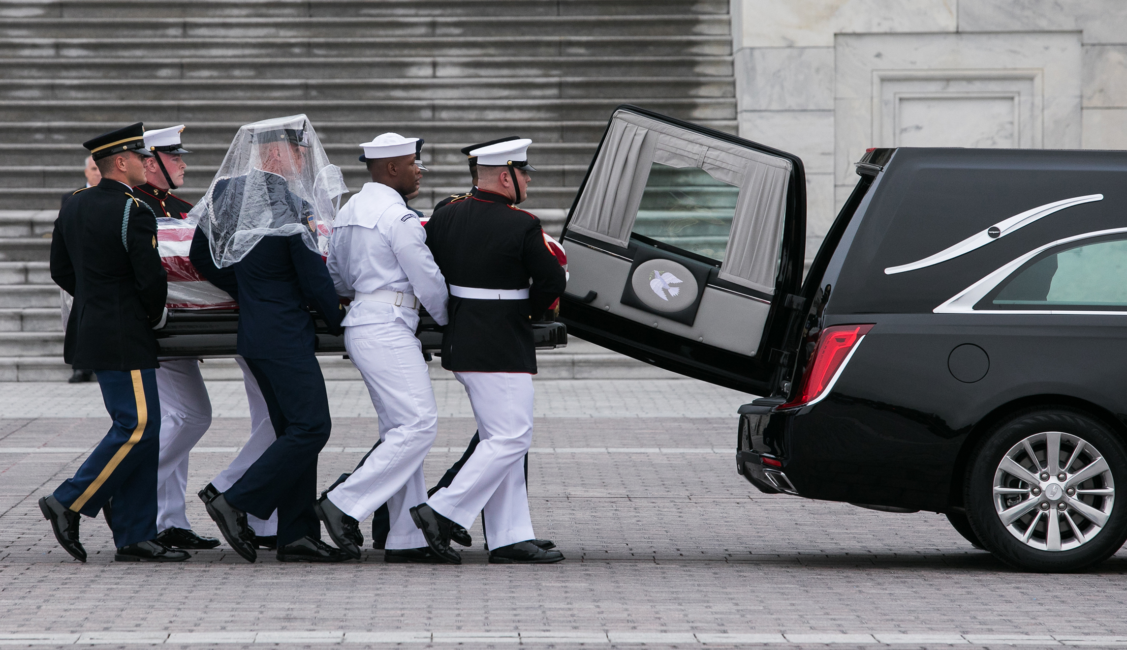 The casket of Sen. John McCain is placed into a vehicle as it leaves the Capitol for the National Cathedral in Washington, D.C. on Saturday.