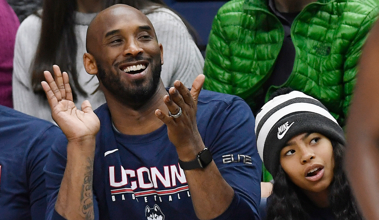 In this March 2, 2019 photo, Kobe Bryant and his daughter Gianna watch the first half of an NCAA college basketball game between Connecticut and Houston in Storrs, Conn. Bryant, the 18-time NBA All-Star who won five championships and became one of the greatest basketball players of his generation during a 20-year career with the Los Angeles Lakers, died in a helicopter crash Sunday, Jan. 26, 2020. Gianna also died in the crash. (AP Photo/Jessica Hill)