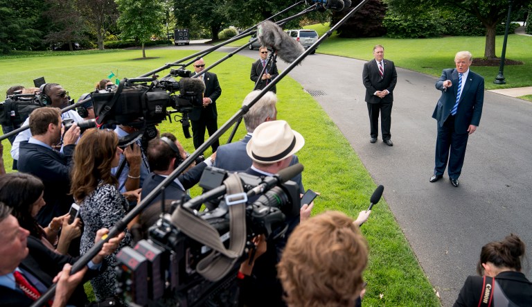 President Donald Trump, right, accompanied by Secretary of State Mike Pompeo, second from right, speaks to members of the media on the South Lawn outside the Oval Office in Washington, Friday, June 1, 2018, after meeting with former North Korean military intelligence chief Kim Yong Chol. After the meeting Trump announced that the Summit with North Korea will go forward.