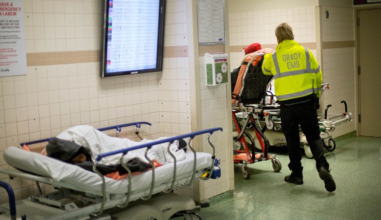 In this Friday, Jan. 24, 2014 photo, an EMS worker wheels a patient through the emergency department at Grady Memorial Hospital, in Atlanta.