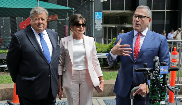 Viktor, left, and Amalija Knavs listen as their attorney Michael Wildes, right, makes a statement in New York, Thursday, Aug. 9, 2018. First lady Melania Trump's parents have been sworn in as U.S. citizens. A lawyer for the Knavs says the Slovenian couple took the citizenship oath on Thursday in New York City. They had been living in the U.S. as permanent residents.