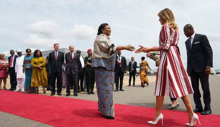 First lady Melania Trump is greeted by Ghana's first lady Rebecca Akufo-Addo as she arrives at Kotoka International Airport in Accra, Ghana, Tuesday, Oct. 2, 2018. Mrs. Trump is visiting Africa on her first big solo international trip, aiming to make child well-being the focus of a five-day, four-country tour.