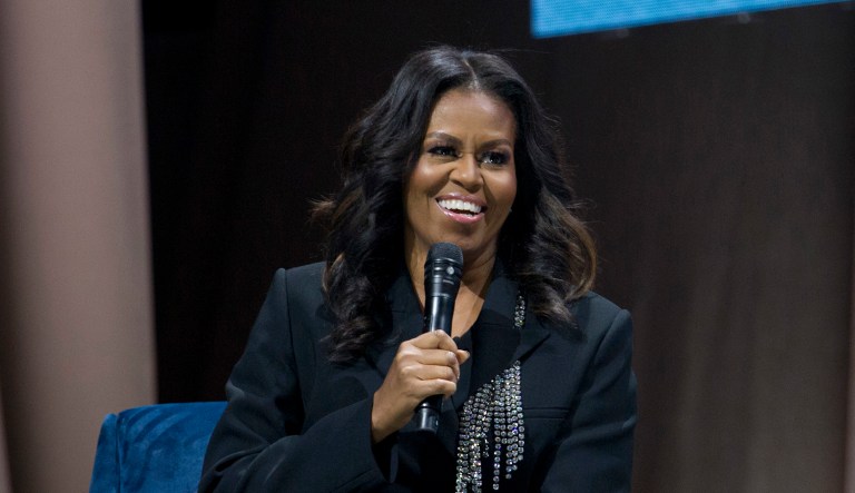 FILE - In this Nov. 17, 2018 file photo, former first lady Michelle Obama speaks to the crowd as she presents her anticipated memoir "Becoming" during her book tour stop in Washington. Crown Publishing tells The Associated Press on Wednesday that the former first lady's memoir has sold more than 1.4 million copies in all formats in the U.S. and Canada in the seven days since it was released Nov. 13.