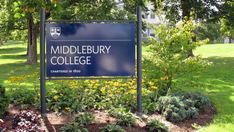 FILE - This Aug. 31, 2017, file photo, shows a sign for Middlebury College on the campus in Middlebury, Vt. A Middlebury College chemistry professor whose written exam question asked students to calculate the lethal dose of a poisonous gas used in Nazi gas chambers during the Holocaust has taken a leave of absence, the school said. 