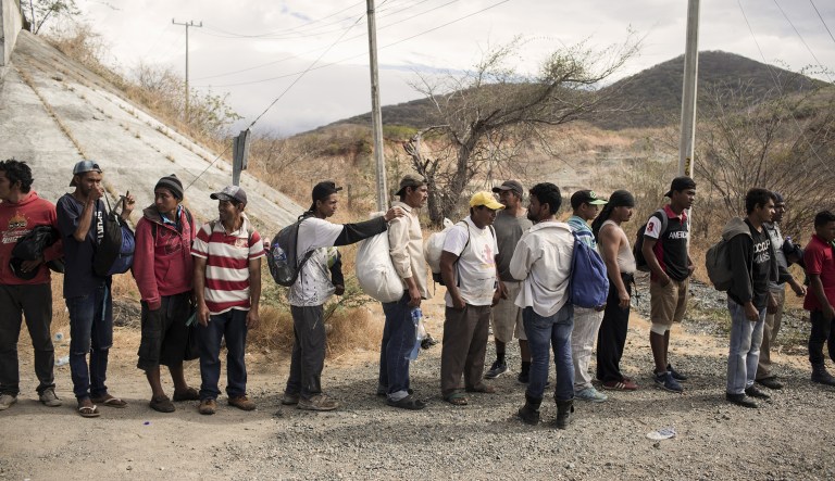 A group of Central American refugees and asylum seekers, led by the non-profit humanitarian organization Pueblos Sin Fronteras (People Without Borders), stand in line to board a public bus in the town of Santiago Niltepec, Oaxaca state, Mexico, on Saturday, March 31, 2018.