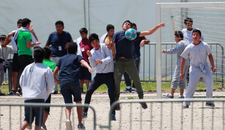 In this April 19, 2019 file photo, migrant children play soccer at the Homestead Temporary Shelter for Unaccompanied Children on Good Friday in Homestead, Fla.