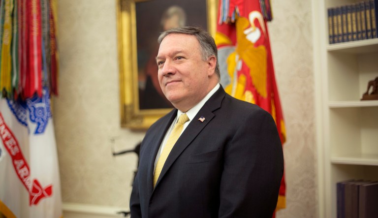 Secretary of State Mike Pompeo stands in the Oval Office of the White House in Washington, Wednesday, Oct. 10, 2018, during President Donald Trump's meeting to discuss potential damage from Hurricane Michael.