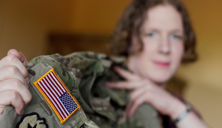 In this July 29, 2017, photo transgender U.S. Army Capt. Jennifer Sims lifts her uniform during an interview with the Associated Press in Beratzhausen near Regensburg, Germany.