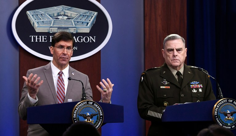 Defense Secretary Mark Esper, left, speaks as Chairman of the Joint Chiefs of Staff Army Gen. Mark Milley, right, listens during a briefing at the Pentagon in Washington, Monday, March 2, 2020.