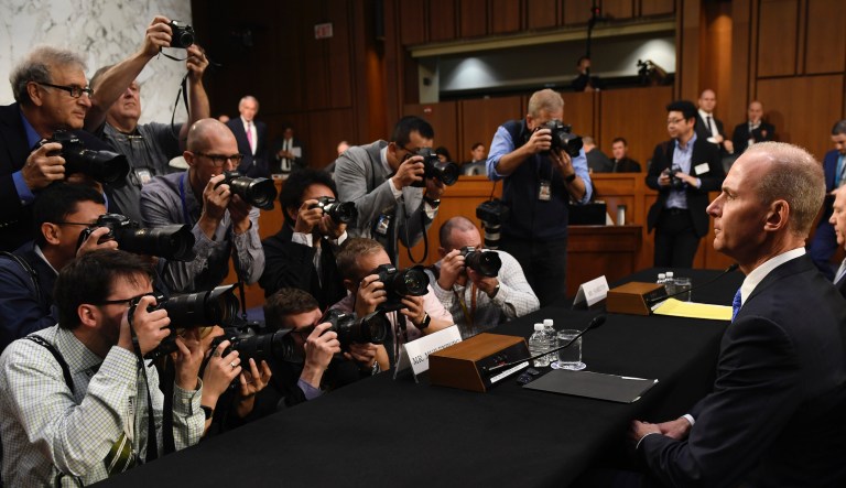 Boeing Company President and Chief Executive Officer Dennis Muilenburg, right, is surrounded by photographers on Capitol Hill in Washington, Tuesday, Oct. 29, 2019, before the start of a Senate Transportation Committee hearing on âAviation Safety and the Future of Boeing's 737 MAX.â                                              
