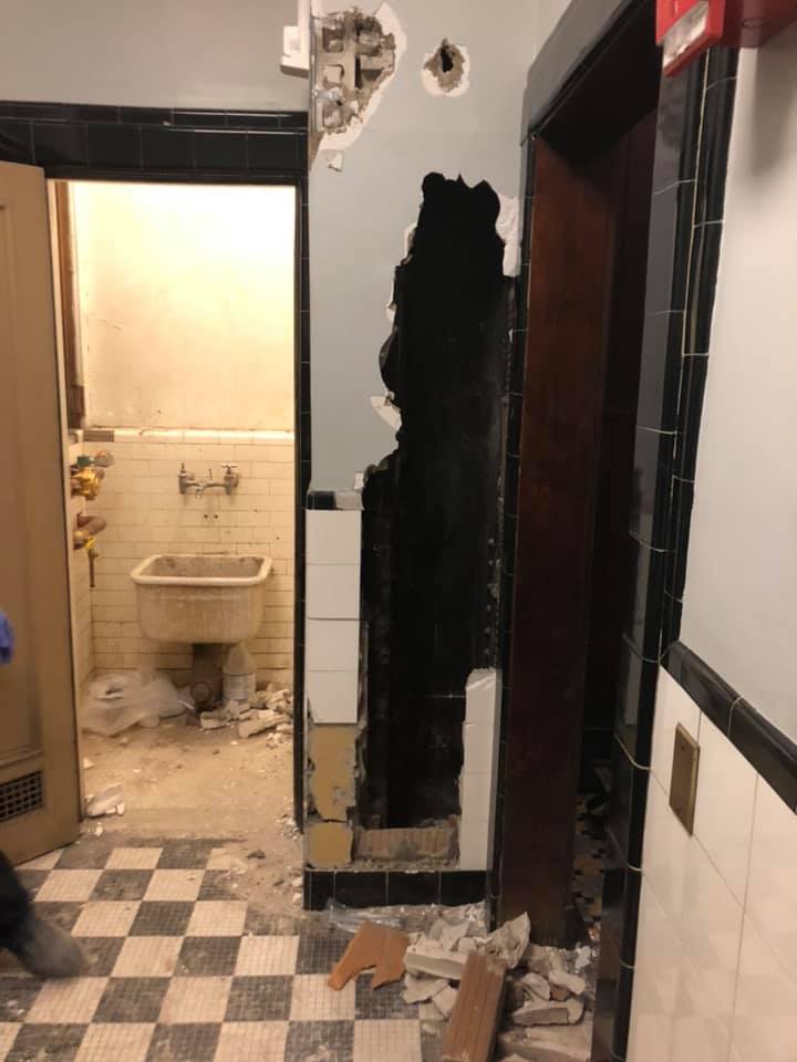 NY firefighters save naked man trapped in theater restroom wall