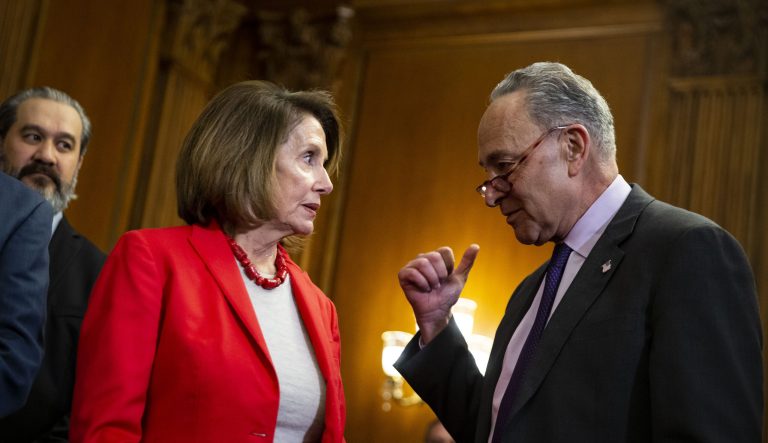 Senate Minority Leader Chuck Schumer, a Democrat from New York, right, speaks to House Speaker Nancy Pelosi, a Democrat from California during a Raise The Wage Act news conference on Capitol Hill in Washington, D.C., U.S., on Wednesday, Jan. 16, 2019. Democrats unveiled a bill to raise the hourly federal minimum wage to $15 â long-shot legislation that would likely require compromise with Republicans to become law.