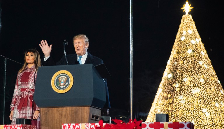President Donald Trump with first lady Melania Trump waves during the National Christmas Tree lighting ceremony at the Ellipse near the White House in Washington, Thursday, Dec. 5, 2019.