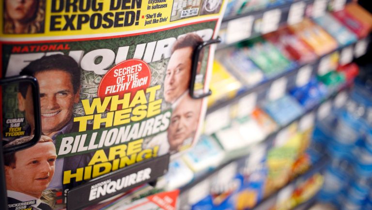 National Enquirer tabloid newspapers are displayed for sale in a grocery store checkout lane in Louisville, Kentucky, U.S., on Thursday, Feb. 14, 2019. The publisher of the National Enquirer, currently under attack byÂ Amazon.com Inc.Â founderÂ Jeff Bezos, has been facing steep financial losses that have left the once-loyal keeper ofÂ Donald Trump's secrets with more than $1 billion inÂ debtÂ and a negative net worth.