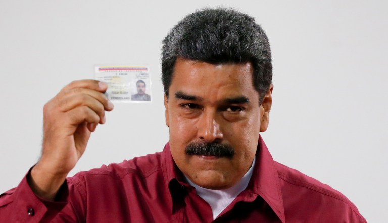 Venezuela's President Nicolas Maduro showed his ID after voting during presidential elections in Caracas, Venezuela, Sunday, May 20, 2018. Amidst hyperinflation and shortages of food and medicine Maduro is seeking a second six-year term in an election that a growing chorus of foreign governments refuse to recognize after key opponents were barred from running.