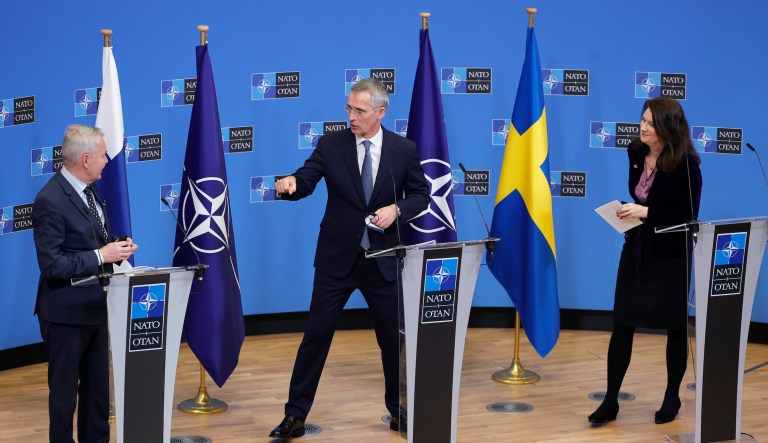 NATO Secretary General Jens Stoltenberg (center) greets Finland's Foreign Minister Pekka Haavisto (left) and Sweden's Foreign Minister Ann Linde (right) at the end of a media conference at NATO headquarters in Brussels on Jan. 24, 2022. 