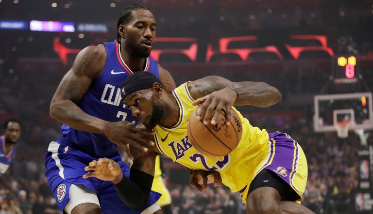 Los Angeles Lakers' LeBron James, right, is defended by Los Angeles Clippers' Kawhi Leonard during the first half of an NBA basketball game Tuesday, Oct. 22, 2019, in Los Angeles.