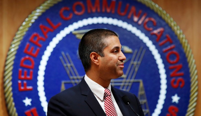 After a meeting voting to end net neutrality, Federal Communications Commission Chairman Ajit Pai smiles while listening to a question from a reporter on Dec. 14, 2017, in Washington.