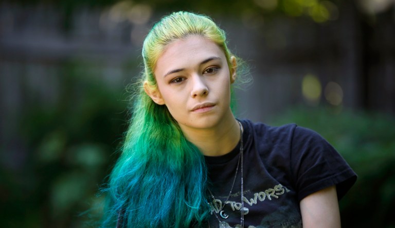 In this Sunday, June 26, 2016 photo Nicole Maines poses at her home in Portland, Maine. Maines, a transgender activist who won a discrimination lawsuit after her school refused to let her use the girls' bathroom will be TV's first transgender superhero. Maines will star in The CW/Warner Bros.' "Supergirl" as Nia Nal, aka Dreamer. Producers describe her character as a "soulful young transgender woman with a fierce drive to protect others."