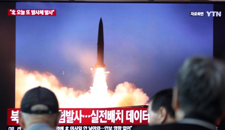 People watch a TV showing a file footage of a North Korea's missile launch during a news program at the Seoul Railway Station in Seoul, South Korea, Friday, Aug. 2, 2019. South Korea's military said North Korea fired unidentified projectiles twice Friday into the sea off its eastern coast in its third weapons tests in just over a week. The sign reads "North Korea fired unidentified projectiles."