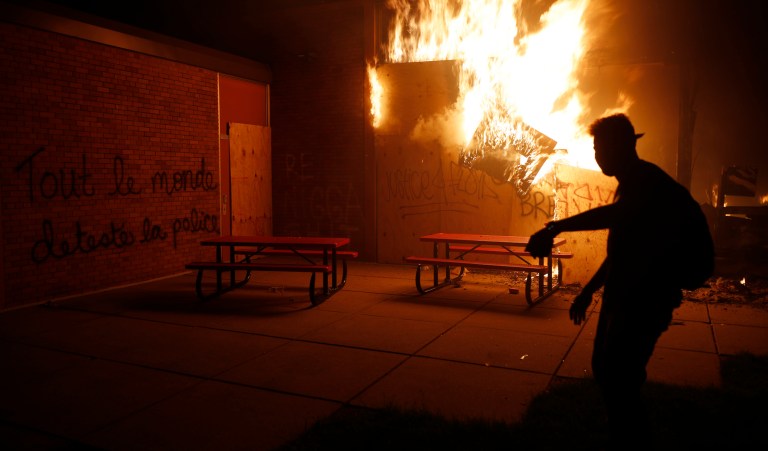People set a fire Friday, May 29, 2020, in Minneapolis. Protests continued following the death of George Floyd, who died after being restrained by Minneapolis police officers on Memorial Day. 