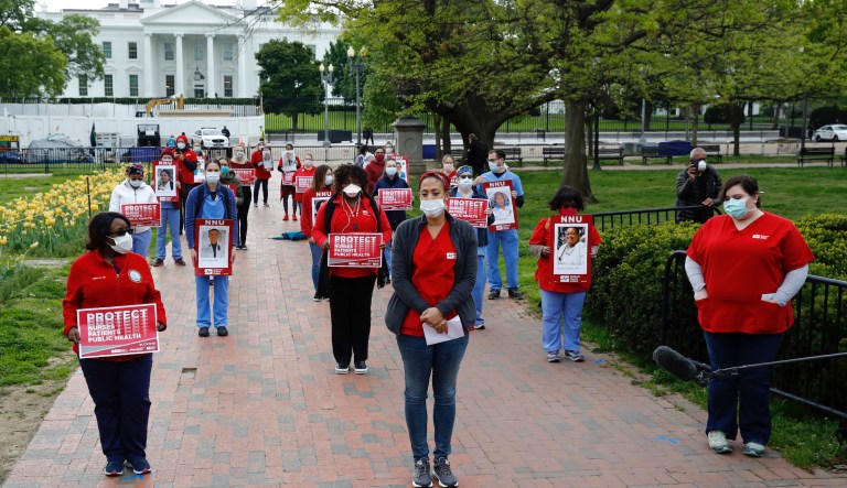 Nurses from National Nurses United practice social distancing as they protest in front of the White House, Tuesday, April 21, 2020, in Washington. The group sought to bring attention to health care workers across the country who have contracted COVID-19 due to a lack of personal protective equipment.