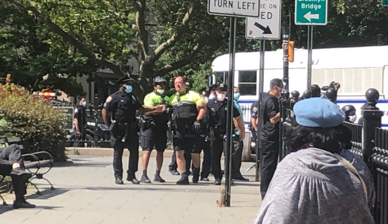 NYPD officers assist fellow officer off the Brooklyn Bridge