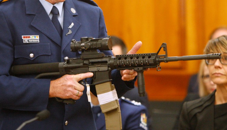 FILE - In this April 2, 2019, file photo, Police Sr. Sgt. Paddy Hannan shows New Zealand lawmakers an AR-15 style rifle similar to one of the weapons a gunman used to slaughter 50 people at two mosques, in Wellington, New Zealand.