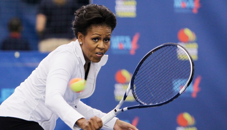 First lady Michelle Obama hits a tennis ball at a U.S. Open tennis clinic highlighting the importance of physical activity for kids at the Billie Jean King National Tennis Center in New York. Michelle Obama is taking her "Let's Move!" campaign to Arthur Ashe Kids' Day.
