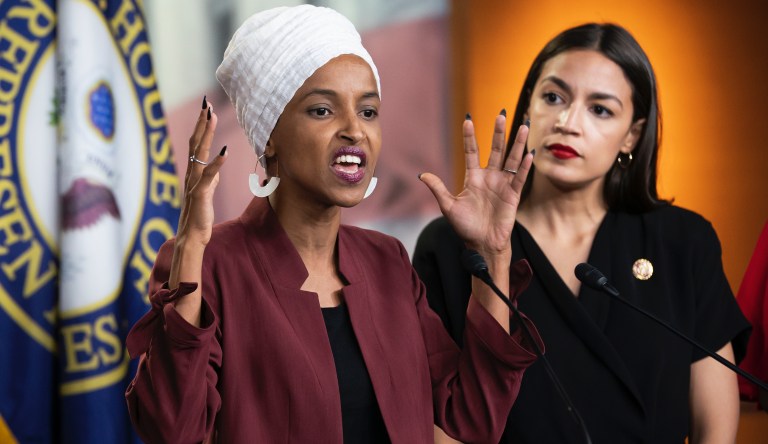 Rep. Ilhan Omar, D-Minn., joined at right by Rep. Alexandria Ocasio-Cortez, D-N.Y., responds to base remarks by President Donald Trump after he called for four Democratic congresswomen of color to go back to their "brokenâ countries, as he exploited the nationâs glaring racial divisions once again for political gain, during a news conference at the Capitol in Washington, Monday, July 15, 2019.