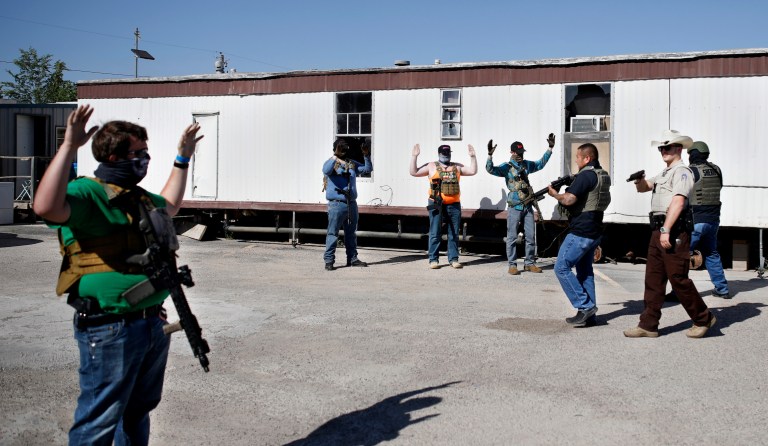 Deputies of the Ector County Sheriffs Office advance on protesters assembling in support of the ability of the bar Big Daddy Zane's to open at full capacity on Monday, May 4th, 2020 in Odessa, TX. Big Daddy Zane's opened on Monday afternoon despite emergency orders prohibiting their operation until later in May. Armed protesters arrived to support the bar's decision, leading to arrest of eight individuals including the bar owner.