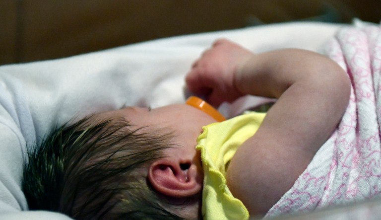 A week old baby lies in one of the ICU bays at one of the Norton Children's Hospital neonatal intensive care units Tuesday, Feb. 13, 2018, in Louisville, Ky. This particular NICU, is dedicated to newborns of opioid addicted mothers, that are suffering with newborn abstinence syndrome, is kept dark and quiet due to increased production of neurotransmitters in newborns of addicted mothers, which can disrupt the nervous system and overstimulate bodily functions.