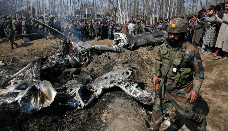 An Indian army solider walks past the wreckage of an Indian aircraft after it crashed in Budgam area, outskirts of Srinagar, Indian controlled Kashmir, Wednesday, Feb. 27, 2019. 