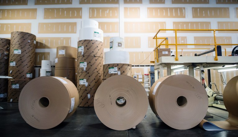 Rolls of raw paper sit on the floor at the Great Little Box Co. manufacturing facility in Vancouver, British Columbia, Canada, on Friday, Aug. 10, 2018. 