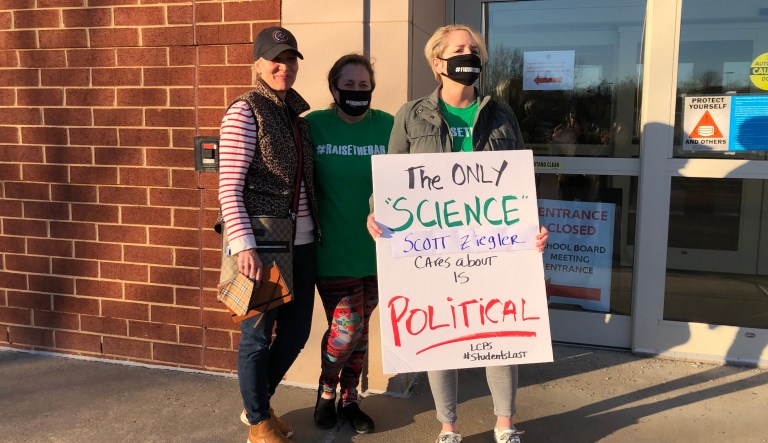 Abby Platt, Carri Michon, and Cheryl Onderchain attend a school board meeting in Loudoun County, Virginia on Feb. 23, 2021. They are pushing for schools to fully reopen for in-person learning.