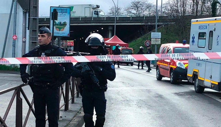 Police officers secure the area after a man attacked passerby Friday Jan.3, 2020 in Villejuif, south of Paris. A man armed with a knife attacked passers-by Friday in a southern Paris park, injuring some, before being shot by police, French officials said.